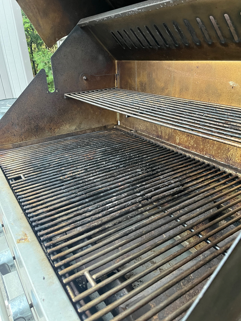 Crown Verity built-in grill before an Aspect deep clean, its cooking grates blackened with baked-on grease and the warming rack streaked brown