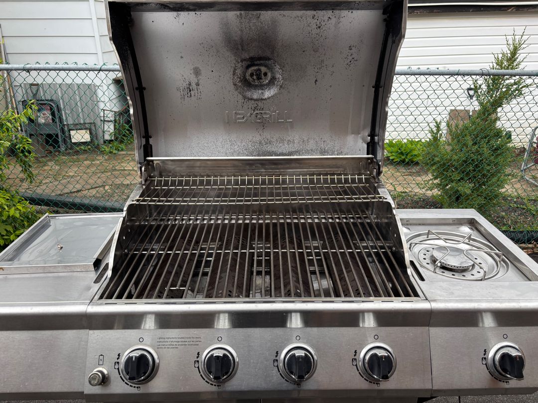 The same five-burner Nexgrill after an Aspect deep clean, with clean grates, a clear burner box, a polished side burner and a wiped-down control panel